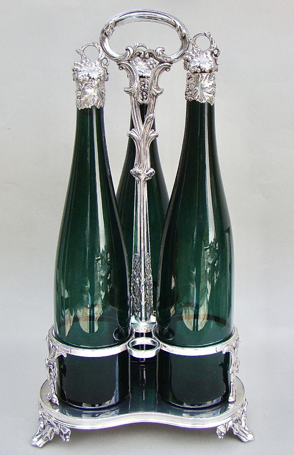 set of three victorian bristol green glass decanter by henry wilkinson co birmingham 1839 in their original silver plated stand