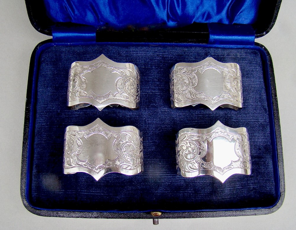 cased set of four edwardian solid silver napkin rings by robert chandler birmingham 1904