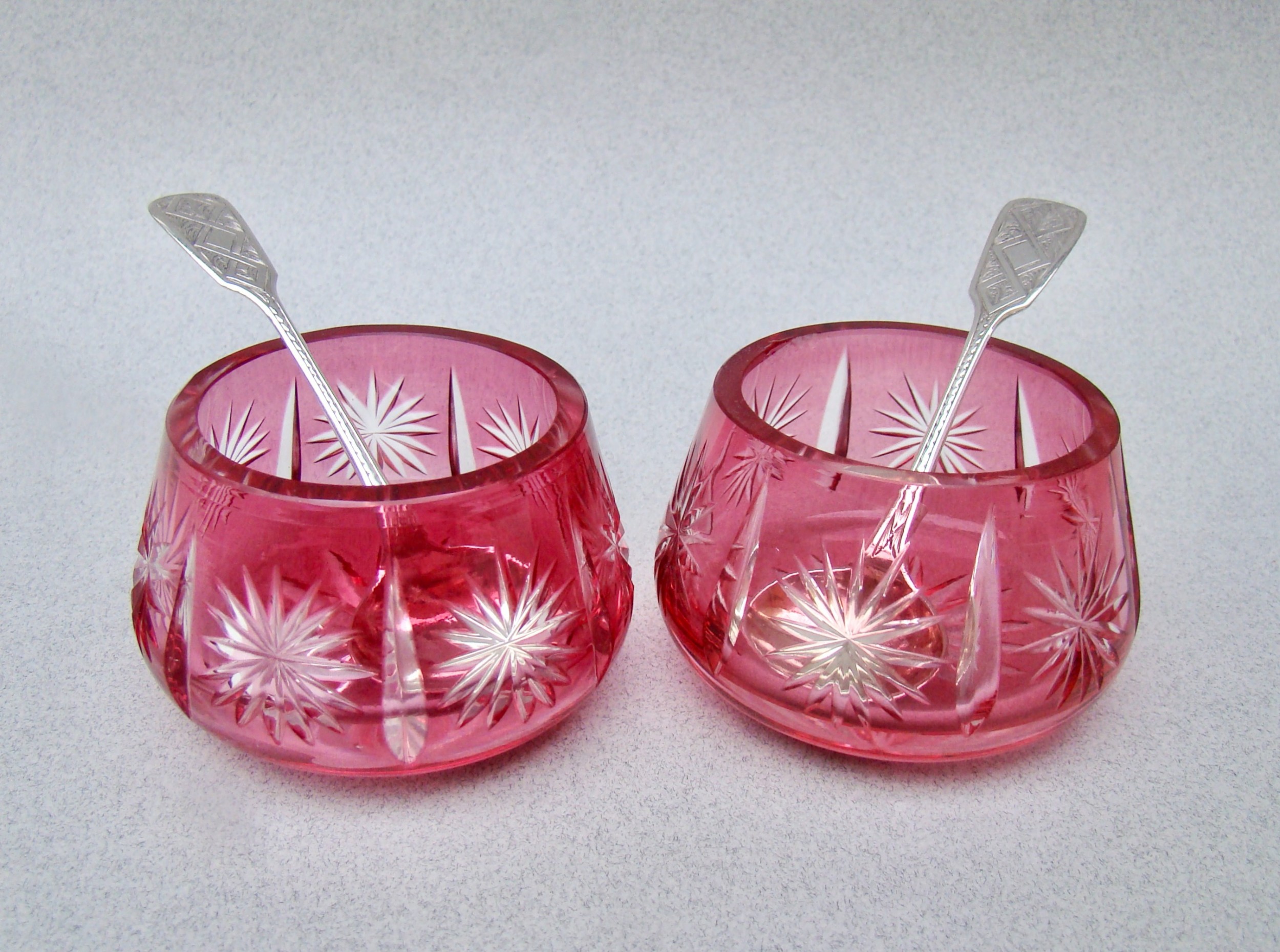 pair of victorian bohemian cranberry glass salts with rare silver spoons by thomas hart stone exeter 1863